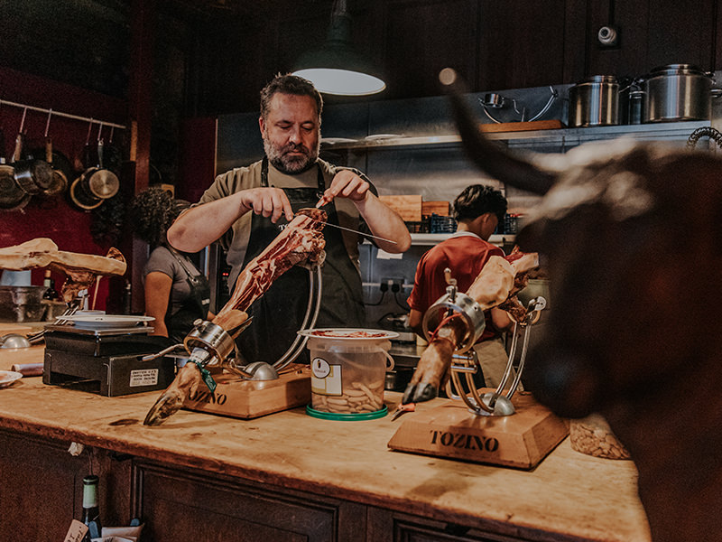 Jamón leg being carved thin